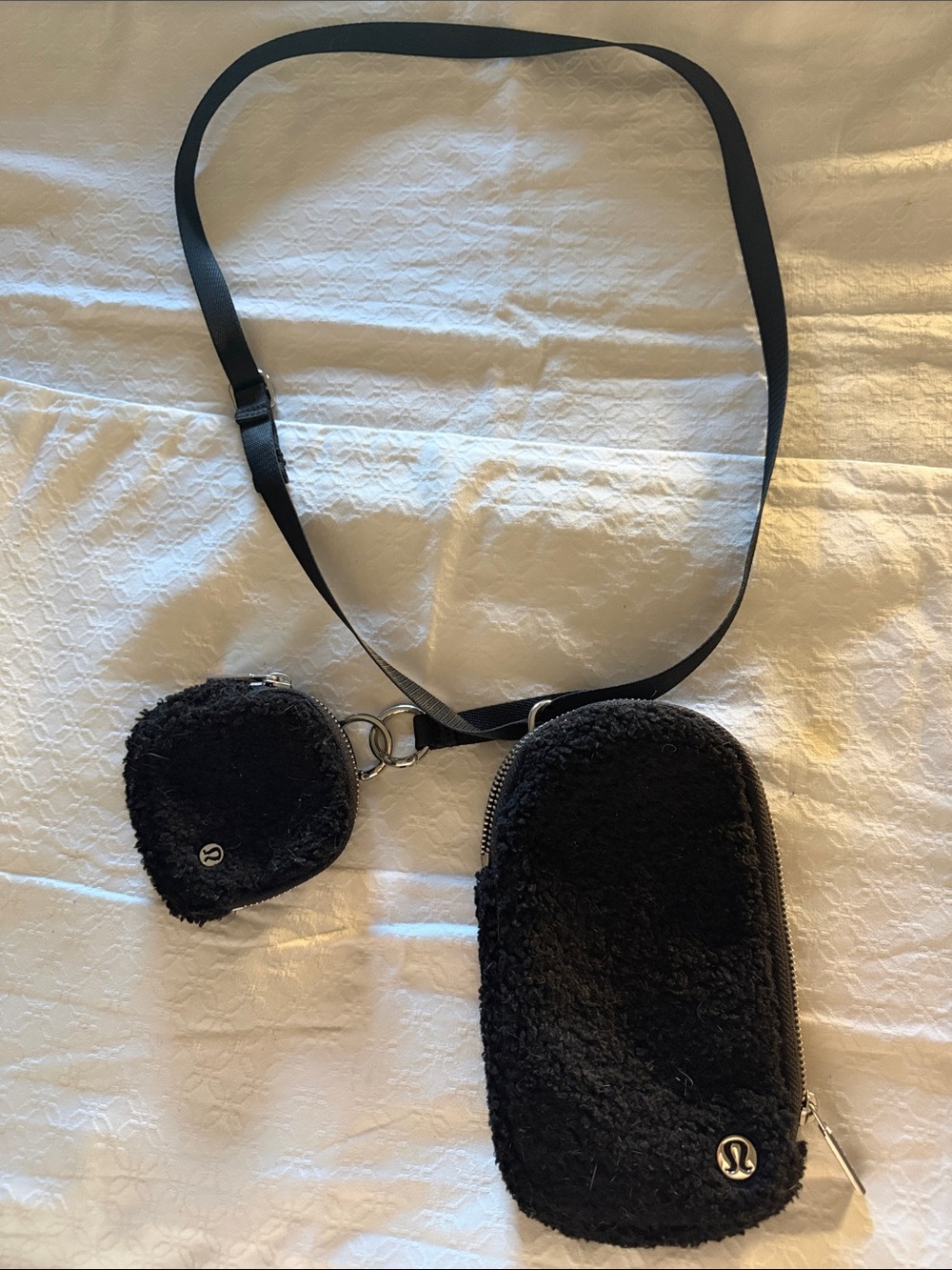 lululemon athletica Black Fuzzy Crossbody Pouch with a detachable small pouch.